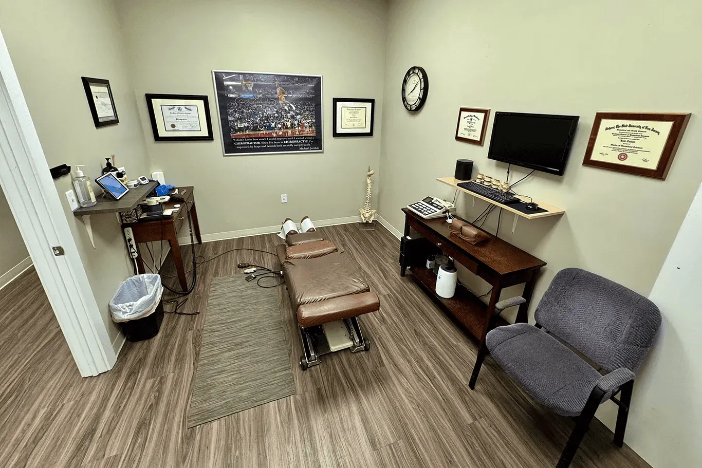 A private chiropractic treatment room with adjustment table and décor