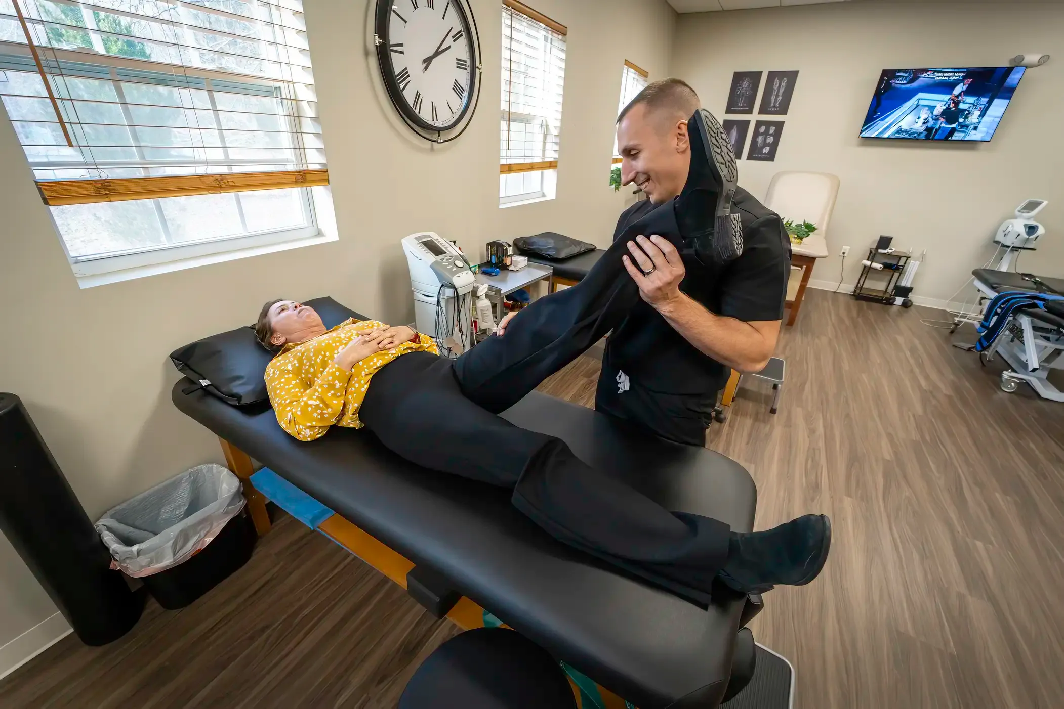 Physical therapist guiding a patient through rehabilitation exercises